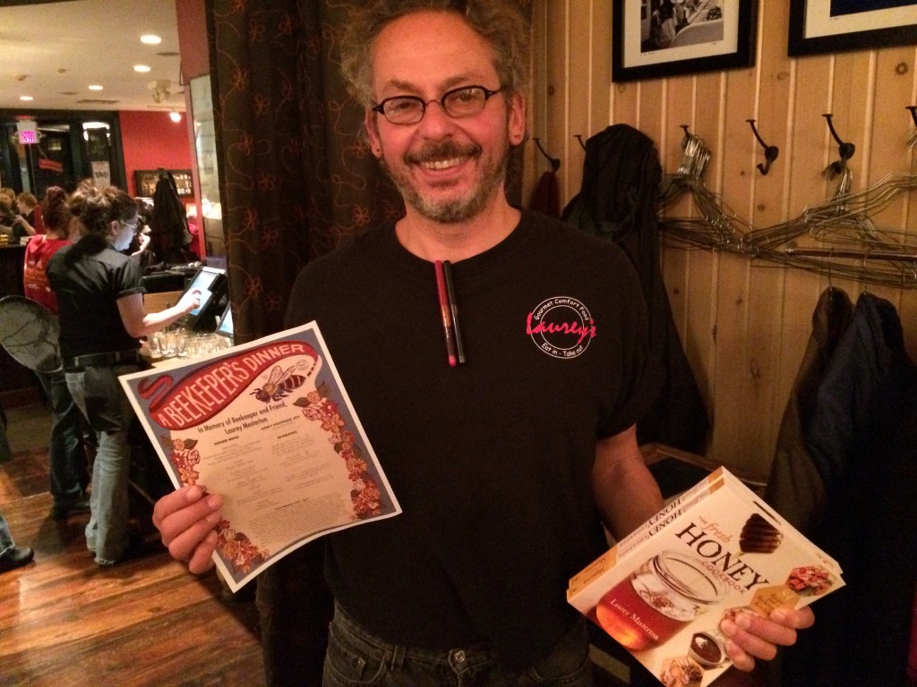 Ari holding the dinner menu and Laurey Masterton's 'The Fresh Honey Cookbook.'