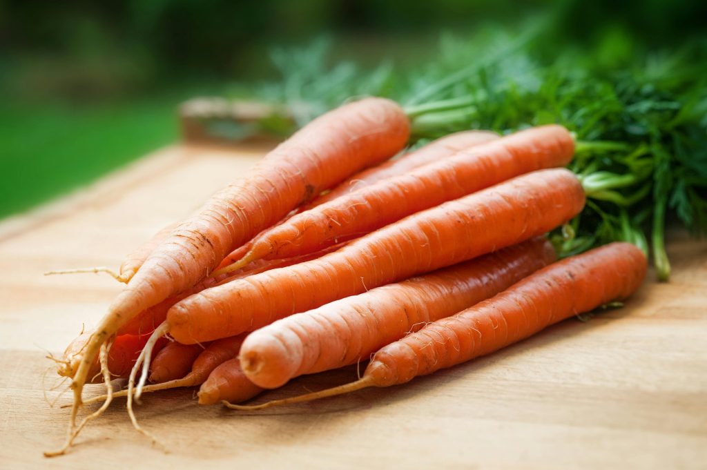 a bunch of carrots on a cutting board