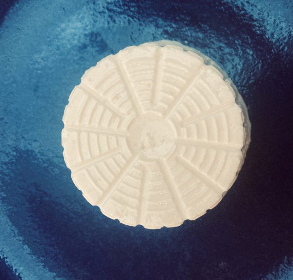 overhead view of ricotta on a blue plate