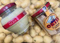 overhead view of a jar of mustard and a jar of tuna on top of mini yukon gold potatoes