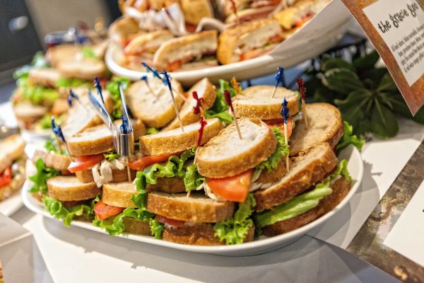 photo of a catering platter stacked with little sandwiches