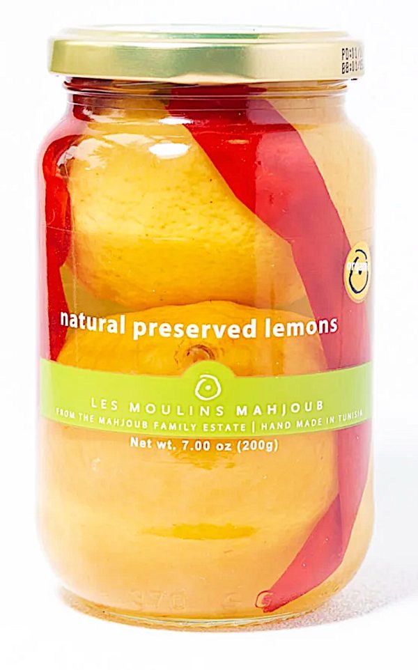 jar of preserved lemons in a red and yellow clear jar with a green stripe across the middle 